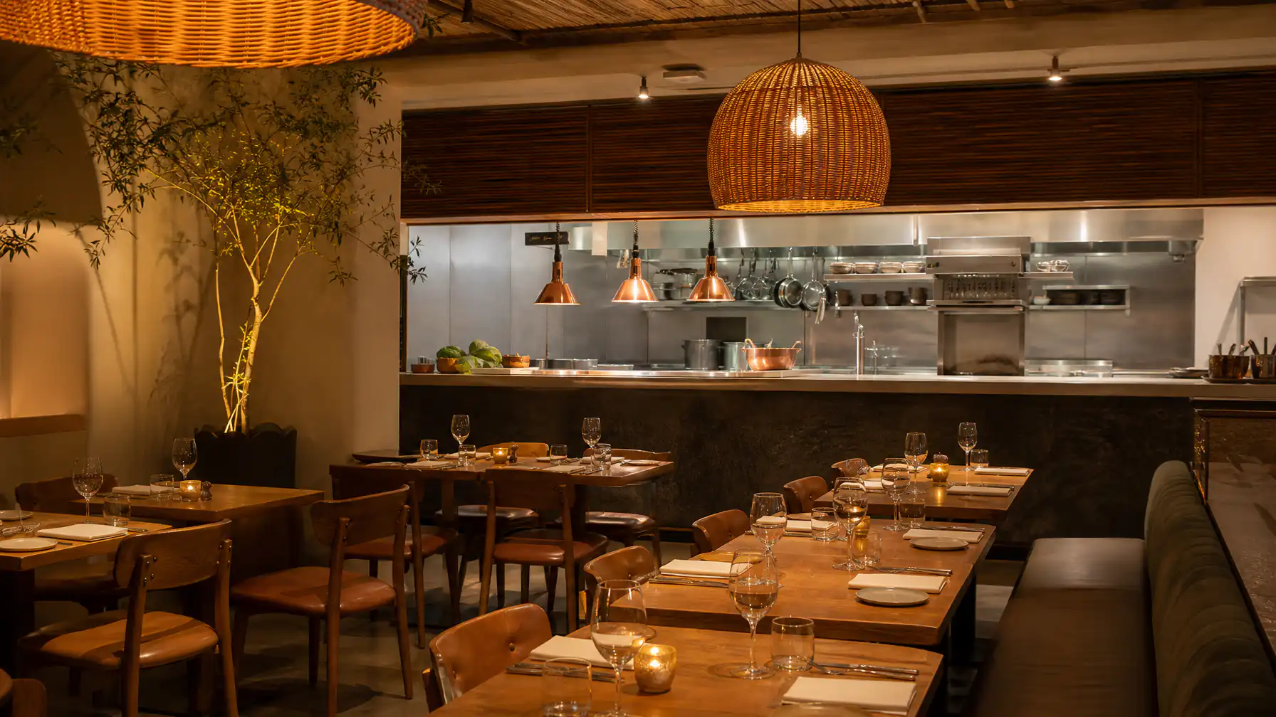 A newly opened South African restaurant with a pristine commercial kitchen visible through the pass and a dining room set and ready for service